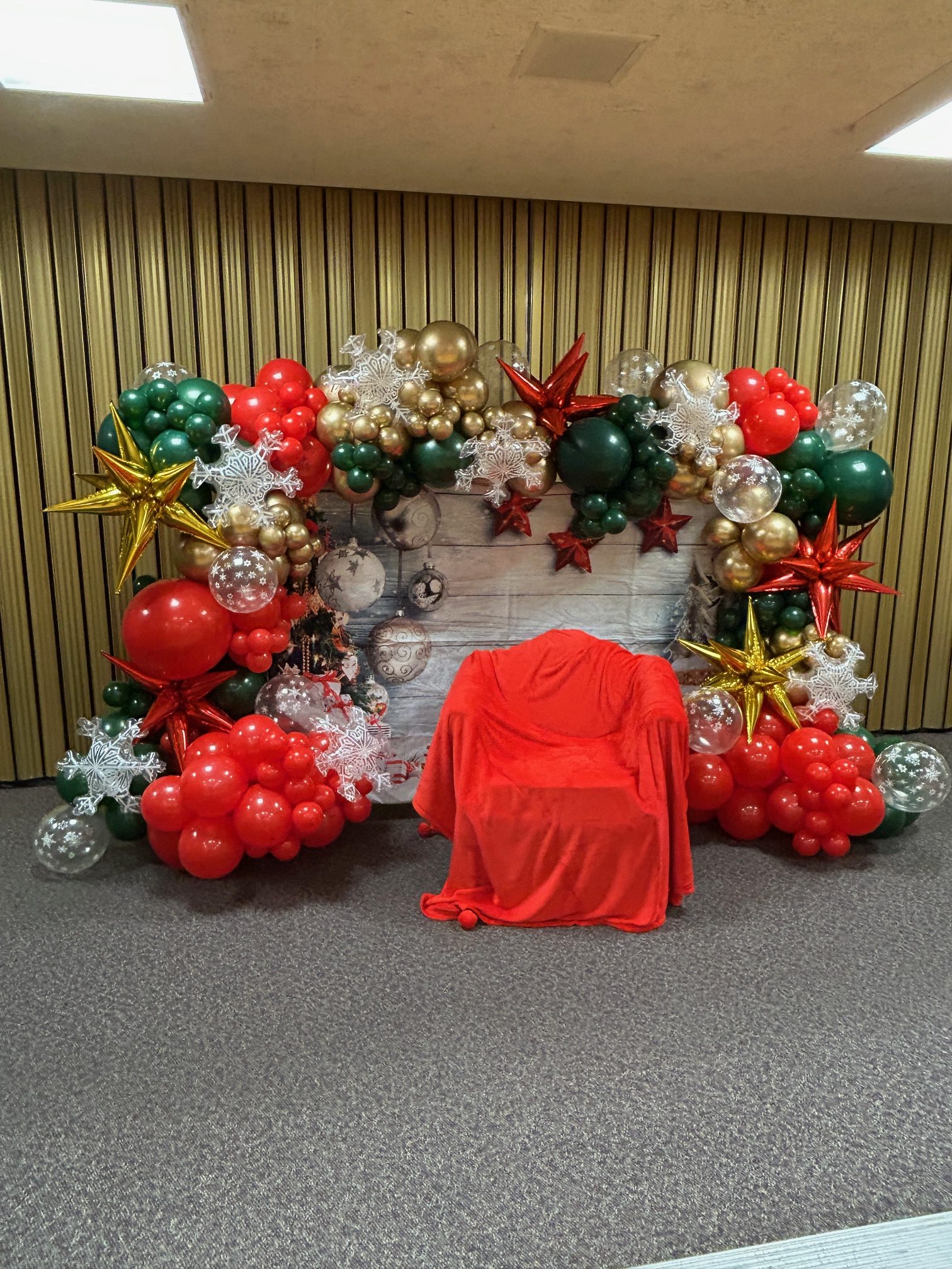 A bright holiday balloon wall and breakfast setup ready for those Christmas jammies photos with Santa.