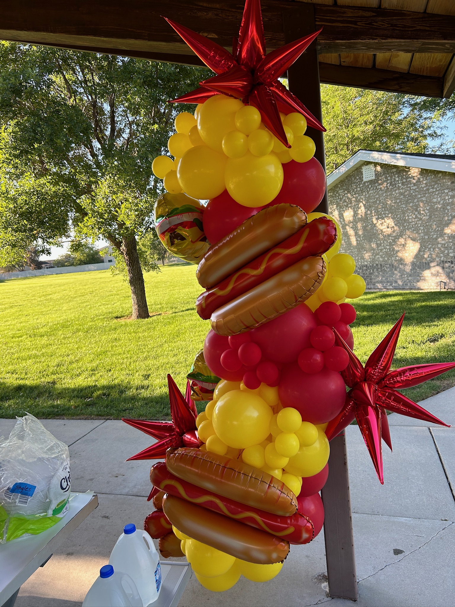 Playful hamburger and hot dog columns in McDonald’s red and yellow for an outdoor celebration.